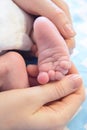 newborn baby legs in parentÃ¢â¬â¢s hands folded by heart, the concept of motherhood, fatherhood Royalty Free Stock Photo
